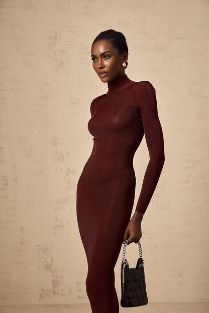 A red semi sheer knitted midi dress with long sleeves and a form fitting silhouette