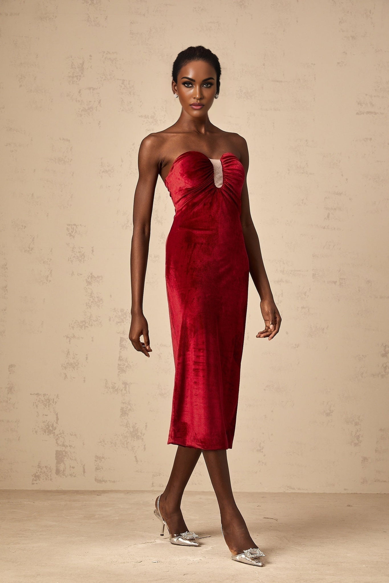 A red velvet midi dress with gathered details named Tiphaine featuring a flowing silhouette and luxurious fabric texture