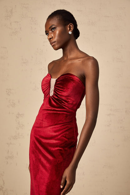 A red velvet midi dress with gathered details named Tiphaine featuring a sleek silhouette and rich fabric texture