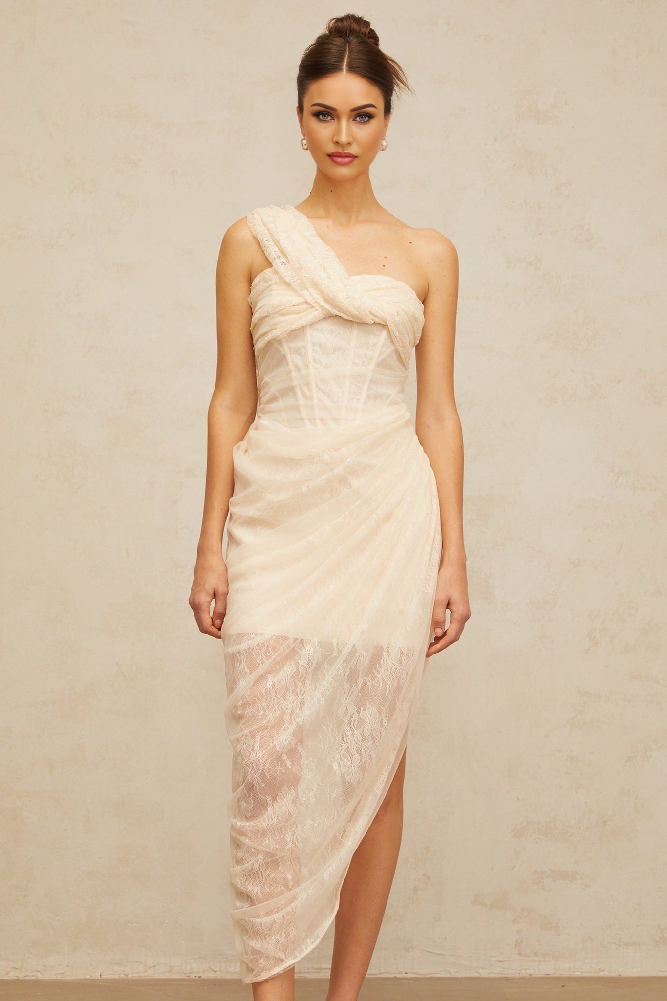 A romantic midi dress with a floral lace design featuring gathered tulle panels and a delicate petunia inspired pattern