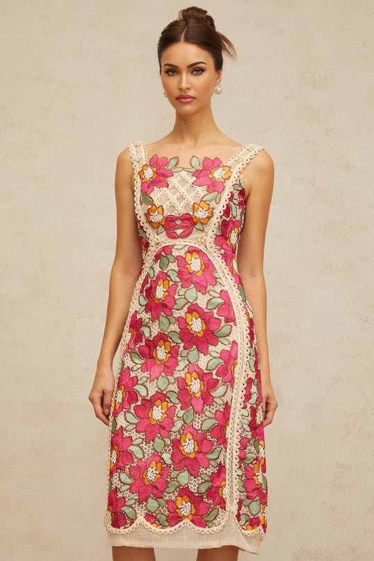 A rosepink midi dress with braided details and floral embroidery featuring a fitted bodice and flowing skirt