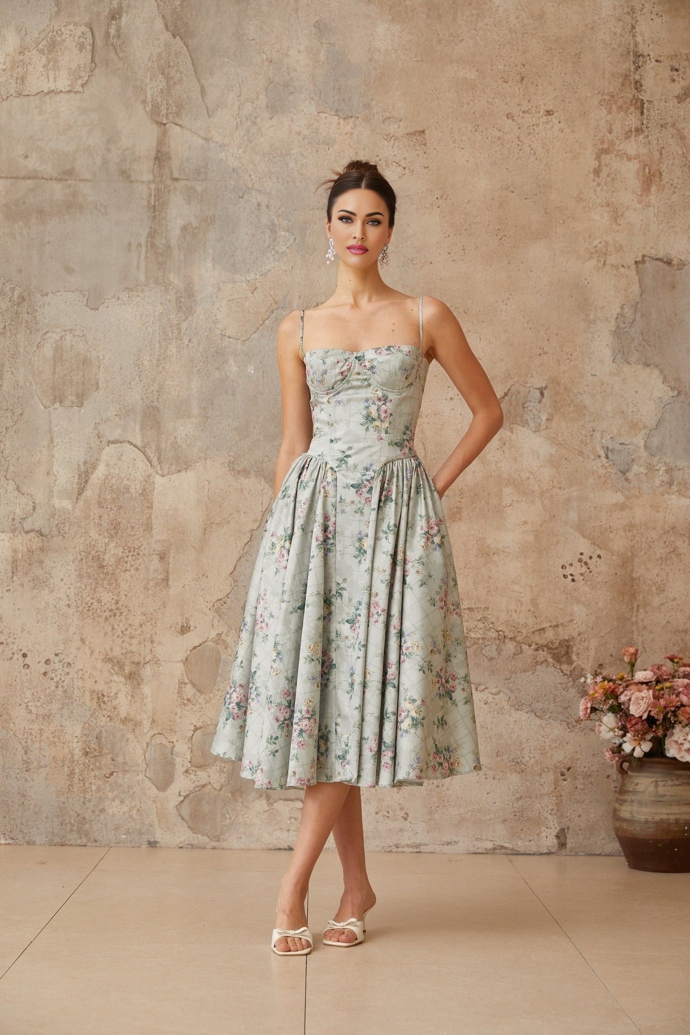 A sagegreen midi dress with a floral print pattern and shirred detailing called Prunelle