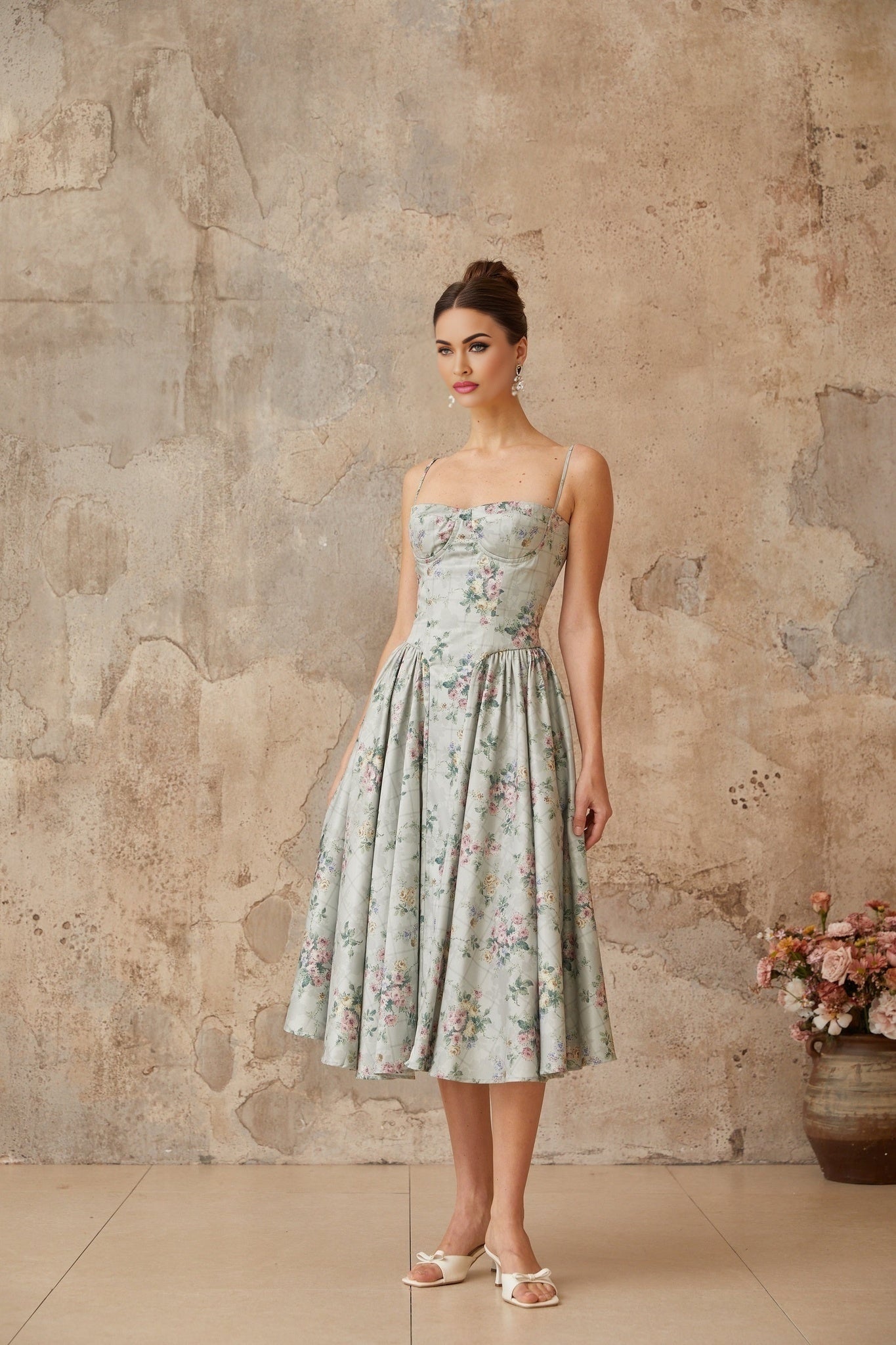 A sagegreen midi dress with a floral print pattern and shirred detailing named Prunelle