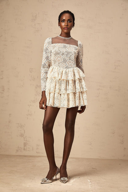 A short beige mini dress with floral embroidery details featuring a relaxed fit and delicate neutral tones