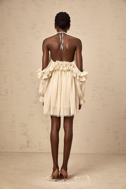 A short beige mini dress with ruffled details and delicate floral appliques in neutral tones