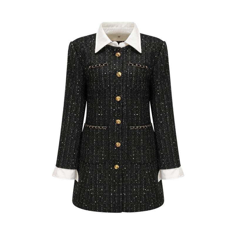 A short black dress with a tweed fabric base and sequin panels featuring a mini length and likely inspired by Audrey Hepburn style