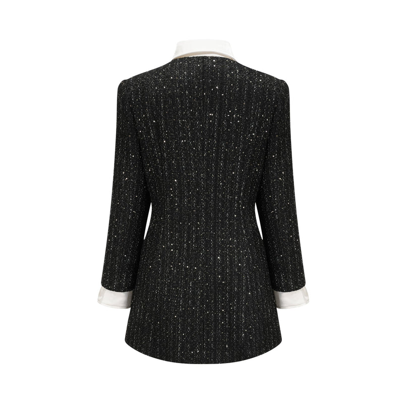 A short black dress with tweed fabric and sequin panels featuring a mini length and Audrey style design
