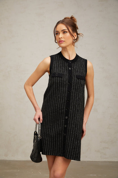 A short black knit mini dress with vertical stripes and sequin embellishments inspired by Zelda style