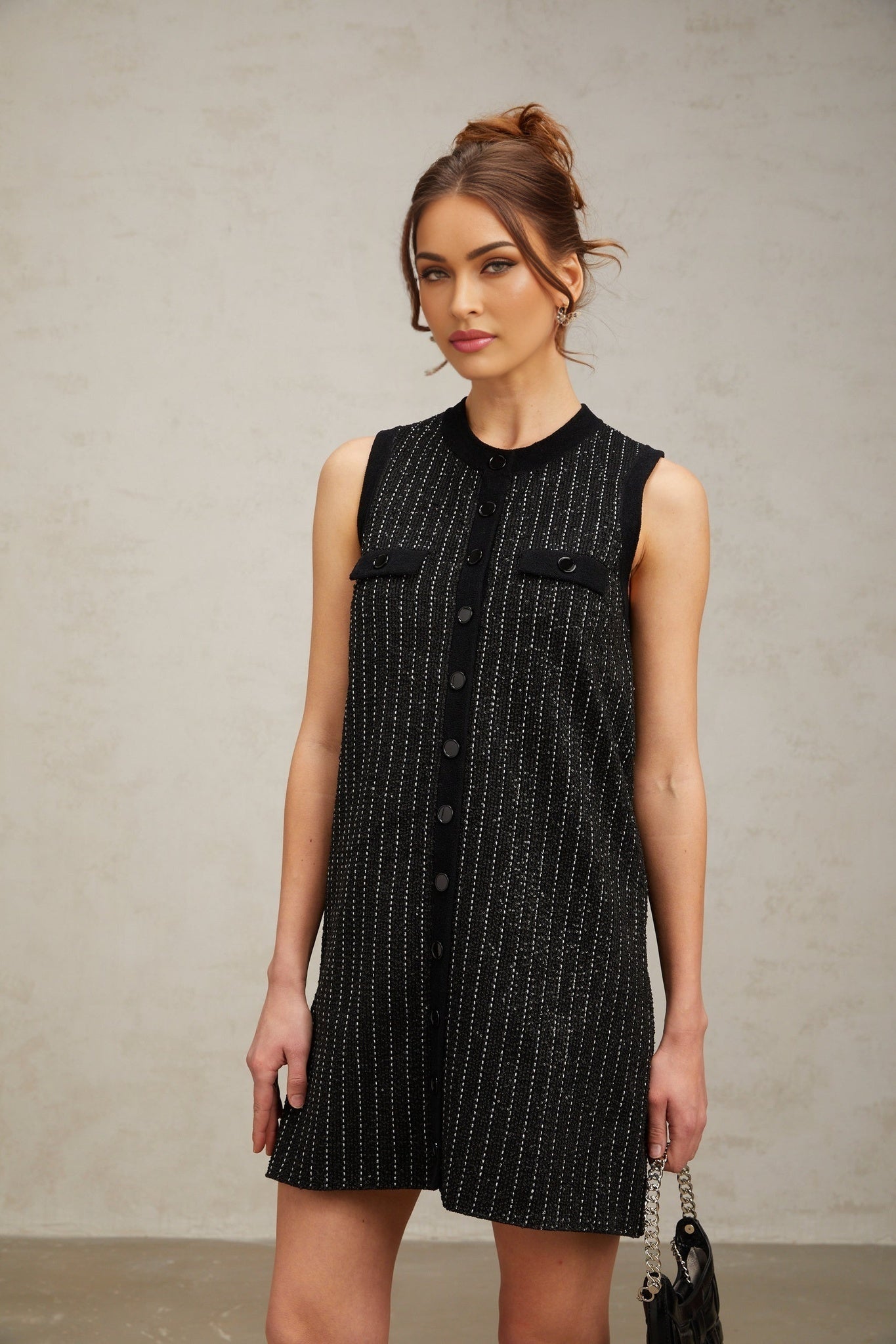 A short black knit mini dress with vertical stripes and sequin embellishments named Zelda