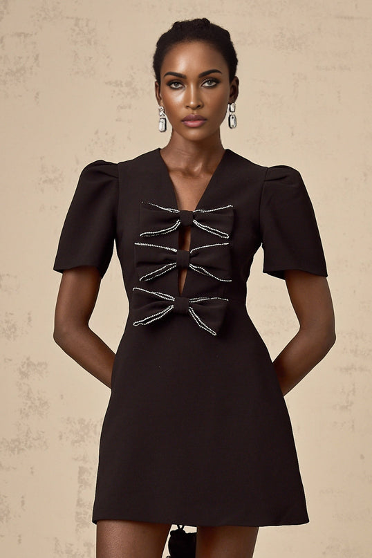 A short black mini dress with a decorative bowknot embellishment