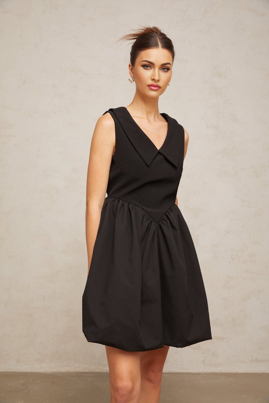 A short black mini dress with a lapel collar and puff sleeves