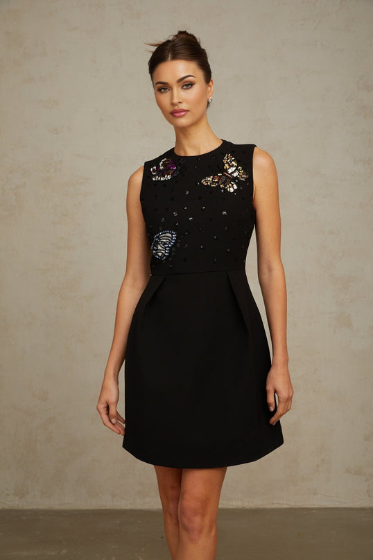 A short black mini dress with sequin embellishments featuring a butterfly design