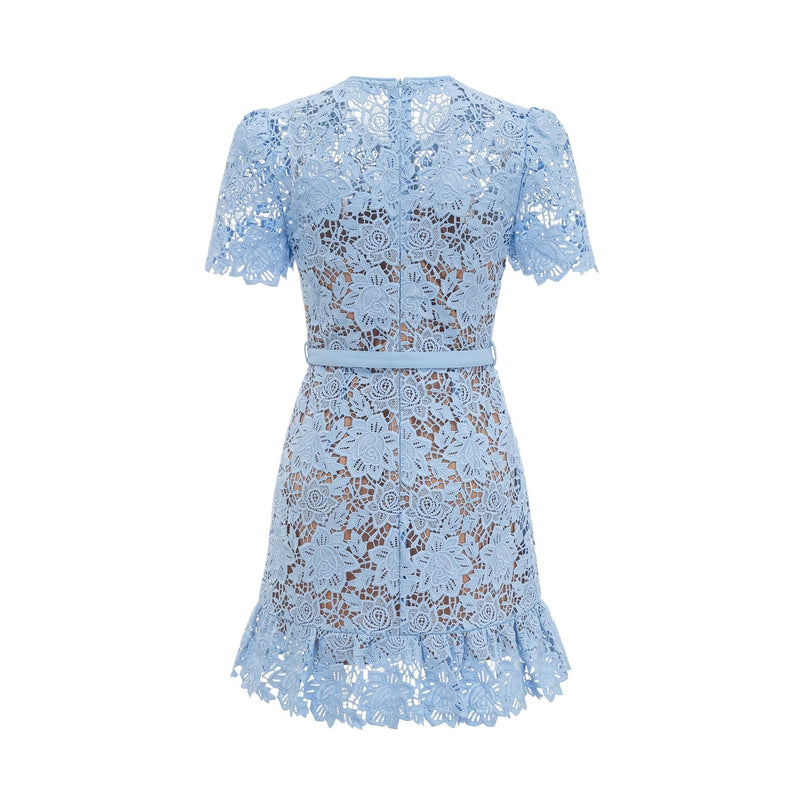 A short blue dress with floral lace appliques and ruffled details on a white background