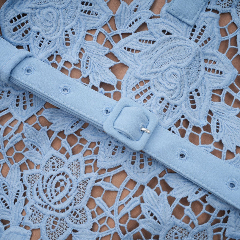 A short blue lace mini dress with ruffled details and floral applique embellishments