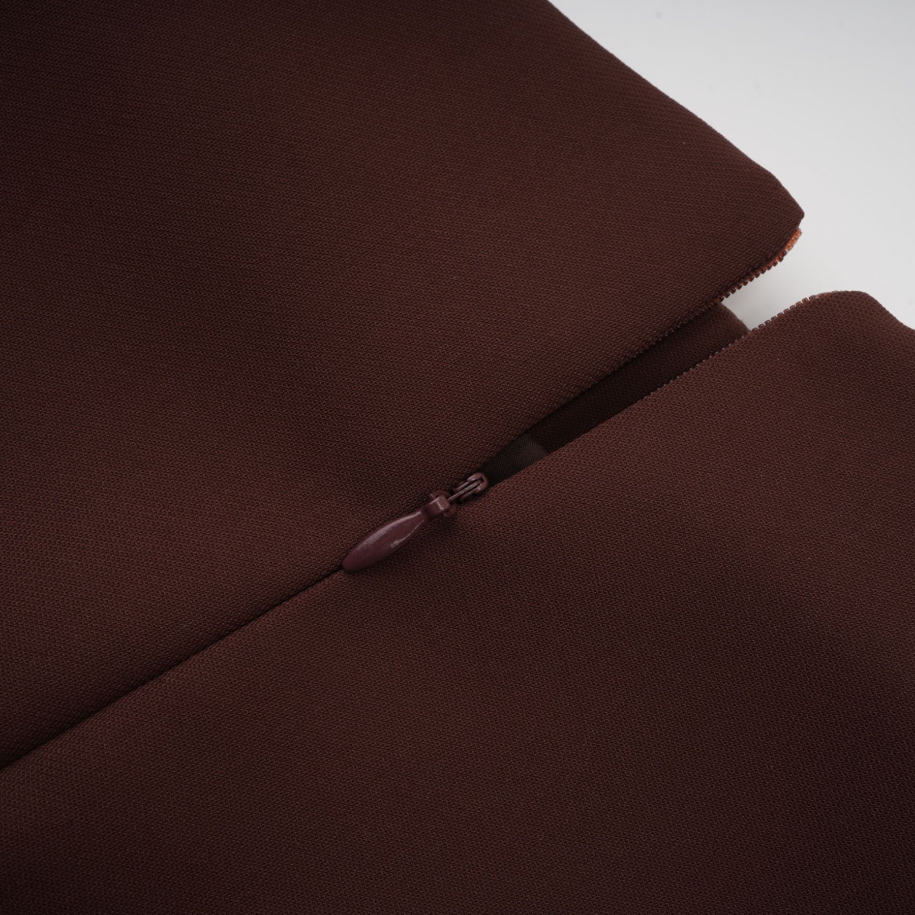 A short brown dress with an asymmetric neckline and puff sleeves in a mini length style named Dora