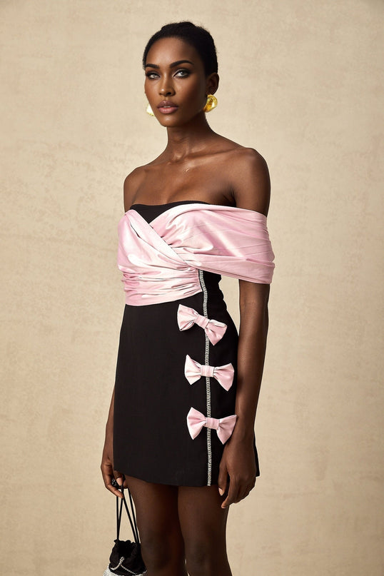 A short colorblocked mini dress with a bow embellishment featuring the name Doria