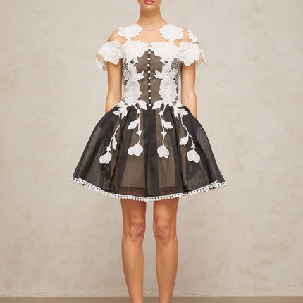 A short colorblocked mini dress with floral embroidery details featuring a mix of contrasting colors and a feminine silhouette