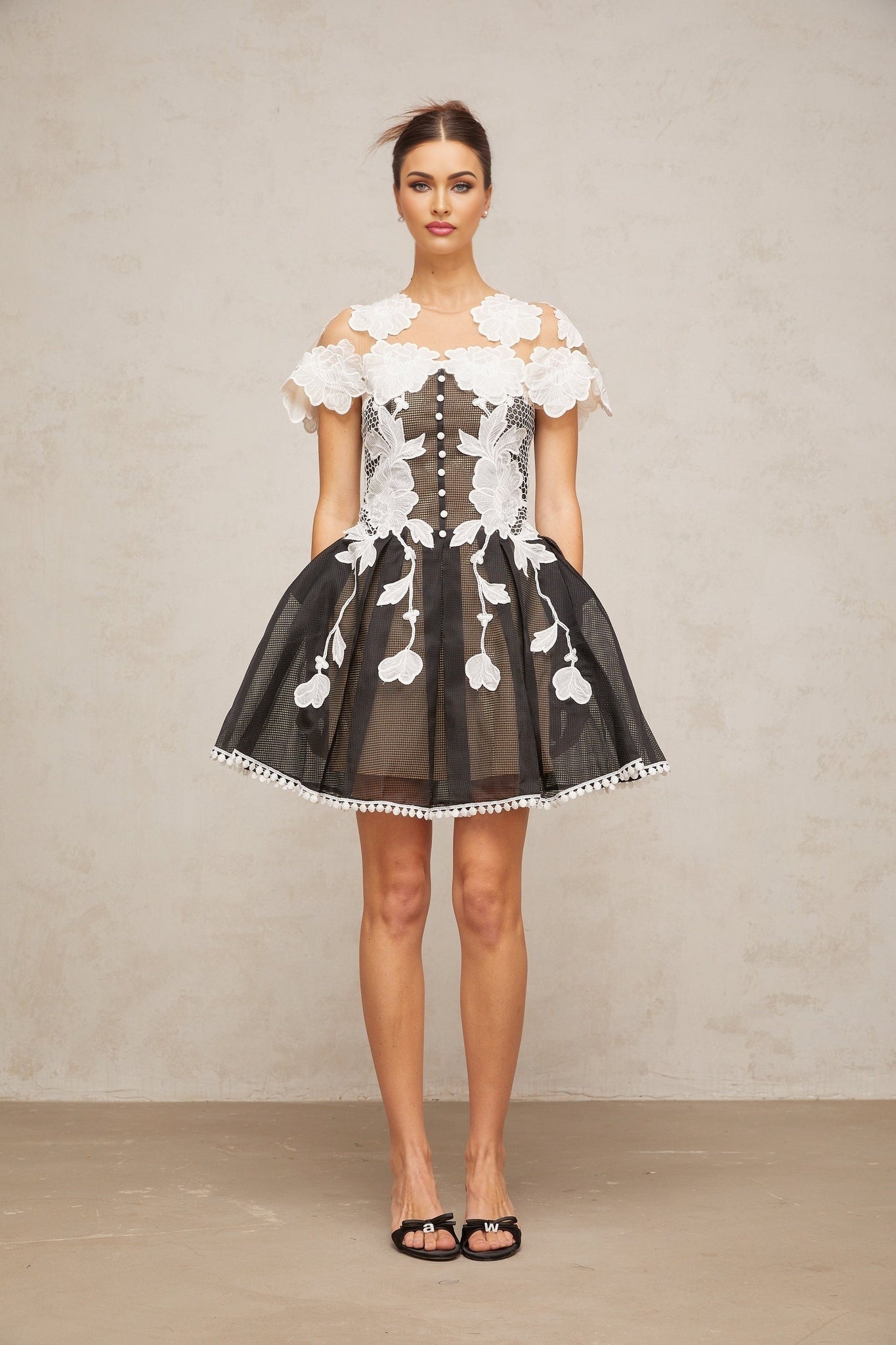 A short colorblocked mini dress with floral embroidery details featuring a mix of contrasting colors and a feminine silhouette