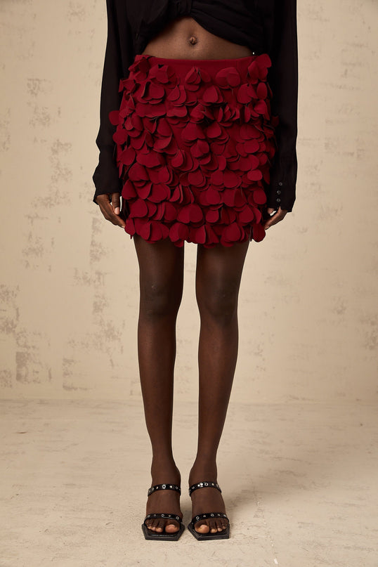 A short flared mini skirt with threedimensional petallike texture in an Aline silhouette named Ettore