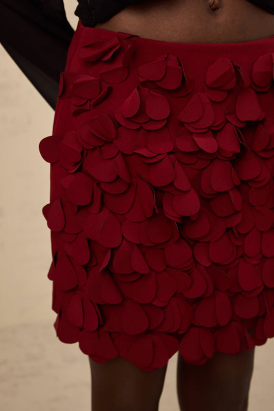 A short flared skirt with three dimensional petal shaped details in an Aline silhouette