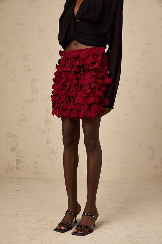 A short flared skirt with three dimensional petallike details in an Aline silhouette