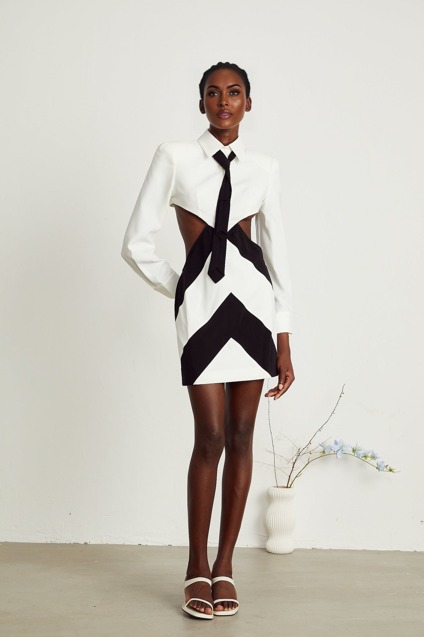 A short flirty mini dress with a neck tie detail and cutout design in the bodice area