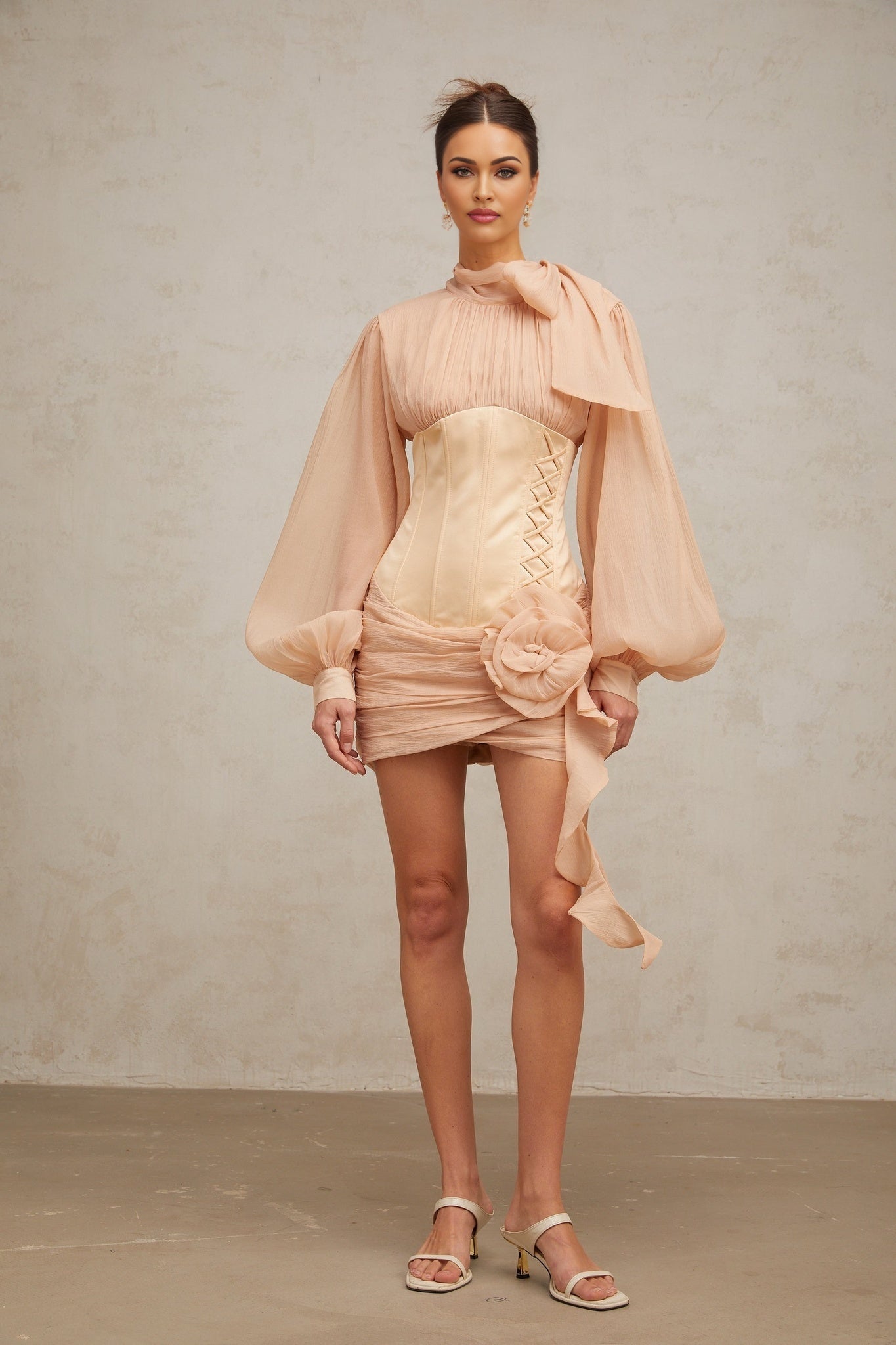 A short floral mini dress with cinched waist and applique details featuring paneled construction in light colors