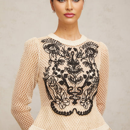 A short floral patterned mini dress with contrasting color applique details and jacquard fabric featuring a floral design