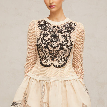 A short floral patterned mini dress with contrasting color floral appliques on a jacquard fabric featuring a design named Wilhelmine