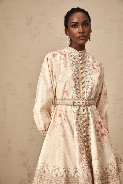 A short floral print mini dress with a belt accent cinched at the waist featuring a vibrant pattern and feminine silhouette