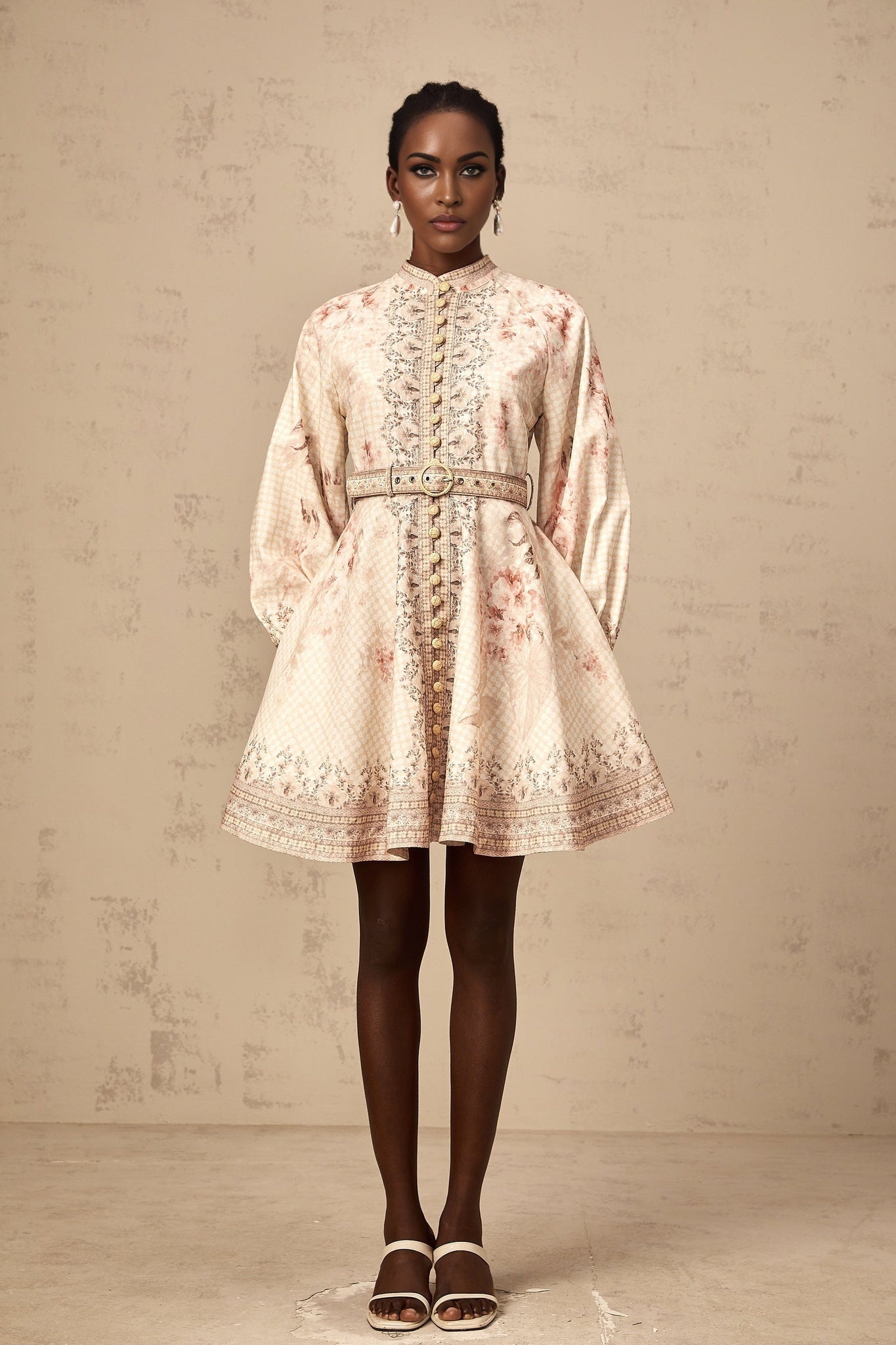 A short floral print mini dress with a belt around the waist featuring a vibrant pattern and a fitted silhouette