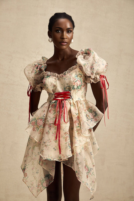 A short floral print mini dress with layered tulle skirt and tieup details named Salome featuring a vibrant floral pattern on a light background