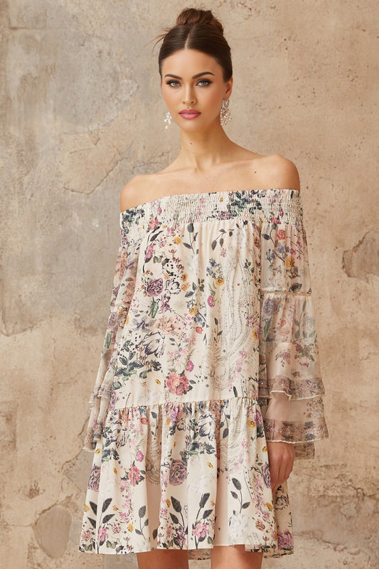A short floral print mini dress with smocked detailing named Yasmine worn by a model against a plain background