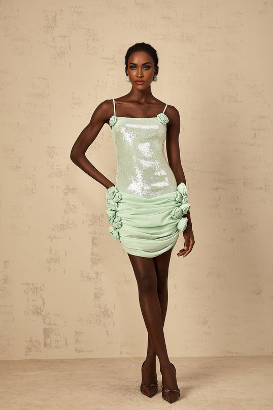 A short green mini dress with floral pattern and sequin embellishments