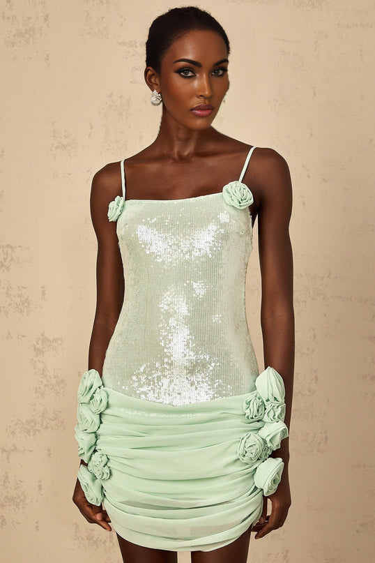 A short green mini dress with floral patterns and sequin embellishments