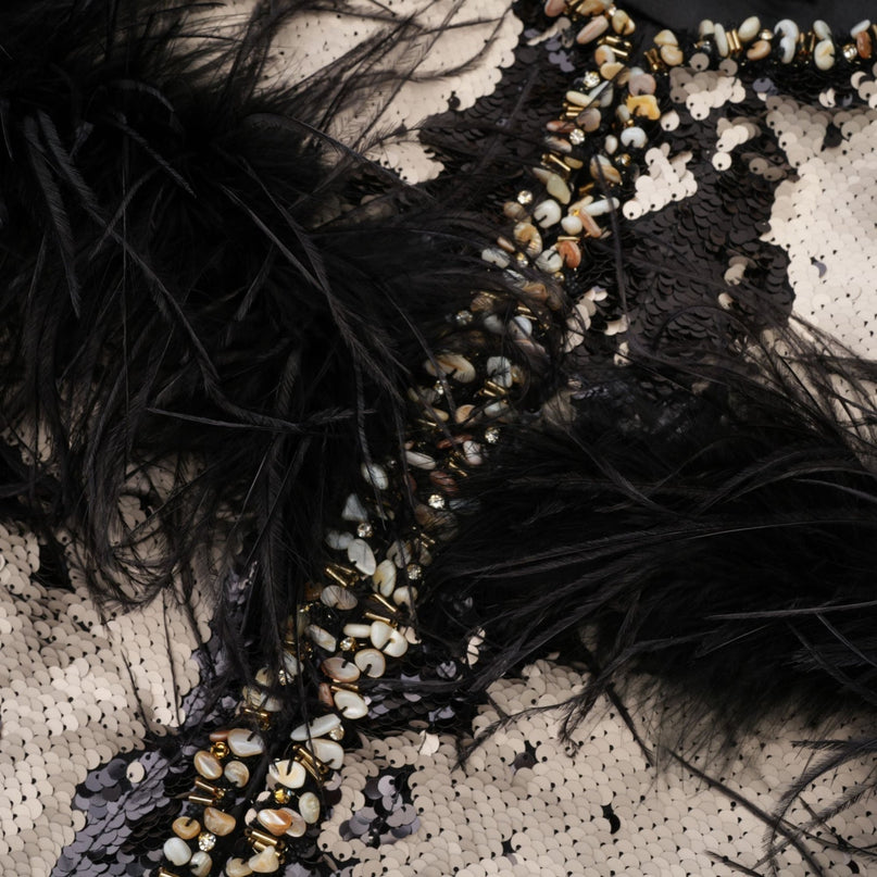 A short jacket with sequins and feather embellishments in a festive design