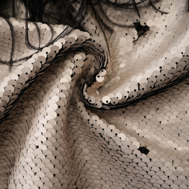 A short jacket with sequins and feather embellishments