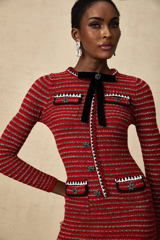 A short knit mini dress with a prominent bow detail likely named Faustine