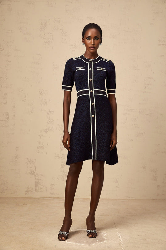 A short navyblue mini dress with a glittery knit fabric named Paulette featuring a shimmering texture and fitted silhouette