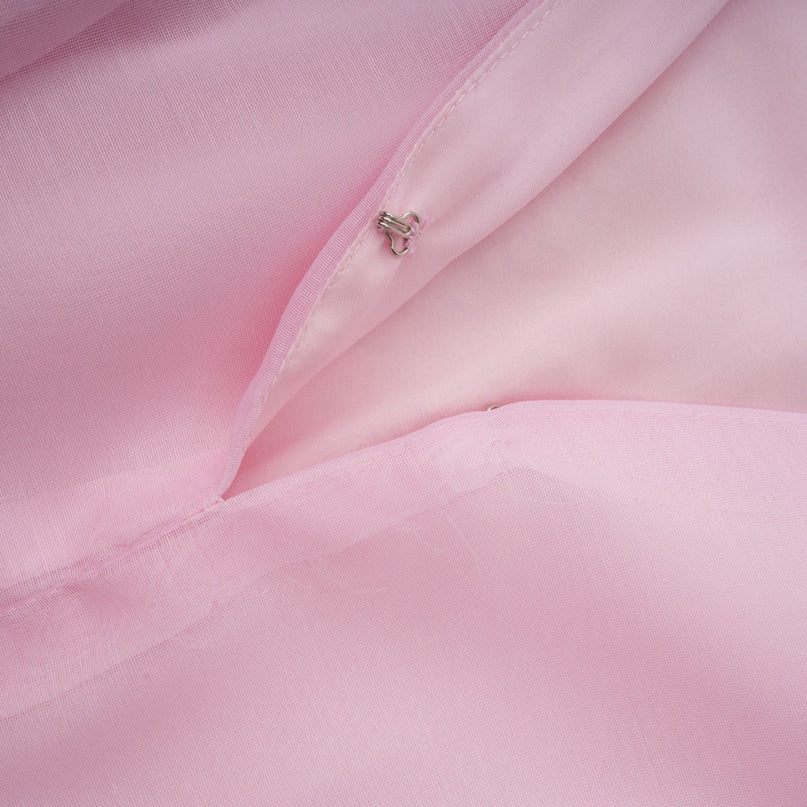 A short pink dress with layered ruffles and floral embroidery details