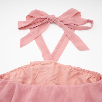 A short pink mini dress with a halter neckline and tiered skirt design in a briar rose shade