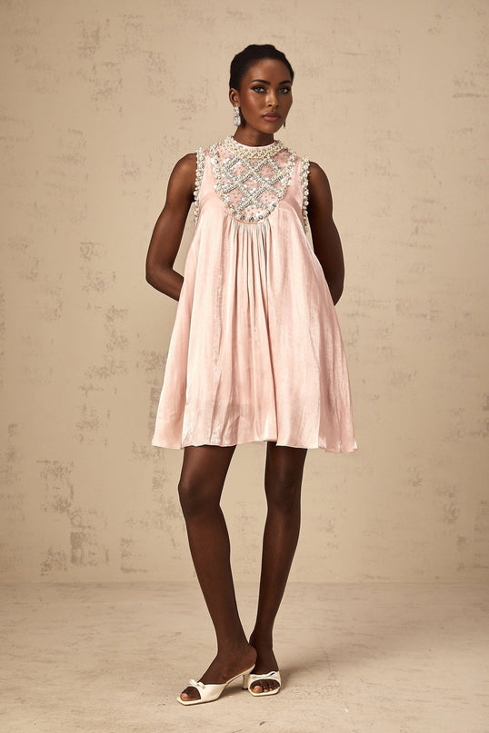 A short pink mini dress with pleated skirt and embellished details named Helena