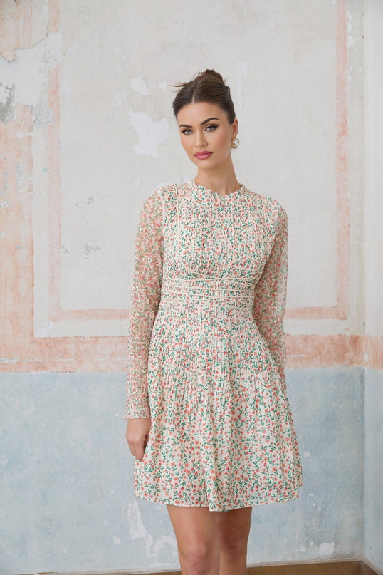 A short pleated mini dress with a floral print pattern featuring Marion design