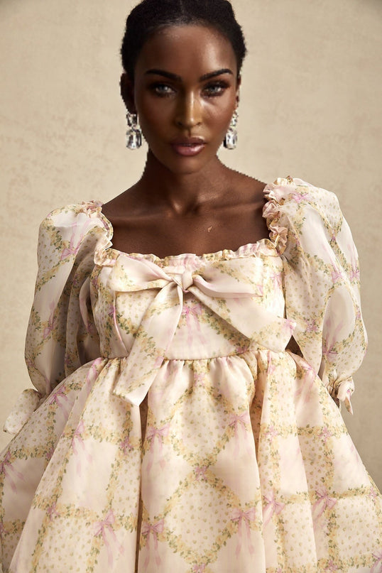 A short puffy mini dress with a check pattern featuring a large bowknot detail in a style called Lou