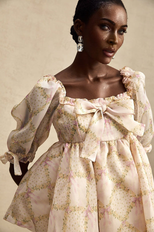 A short puffy mini dress with a Lou check pattern featuring a prominent bowknot detail