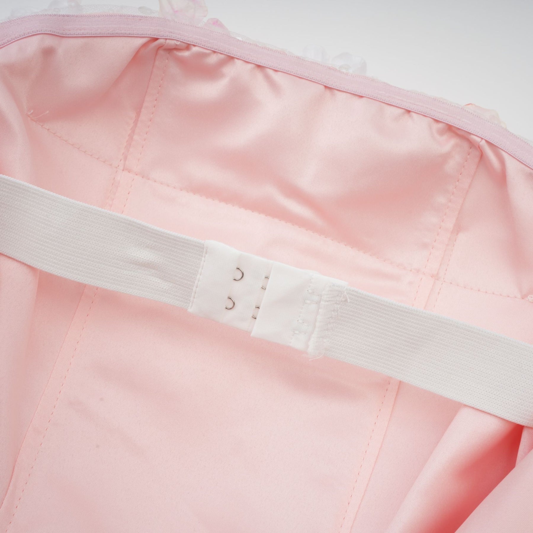 A short puffy mini dress with threedimensional petal details covering the fabric creating a textured floral appearance