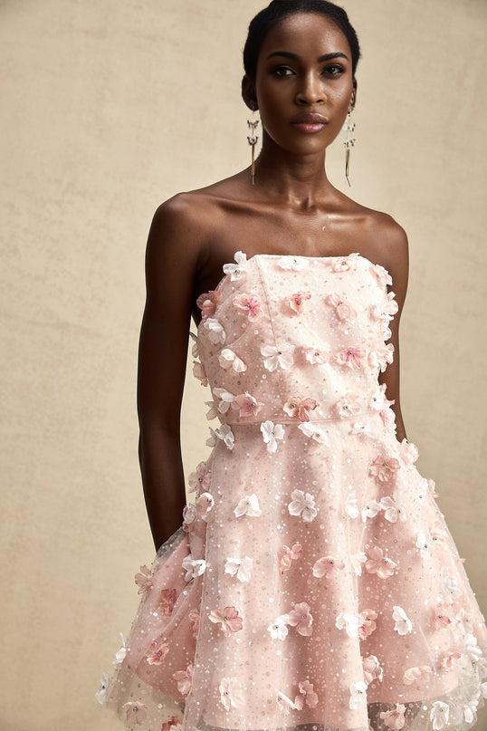 A short puffy mini dress with threedimensional petal details covering the surface creating a textured floral effect
