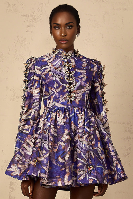 A short purple mini dress with butterfly appliqués decorating the fabric