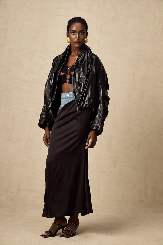 A short quilted leather jacket in black featuring a sleek design with a standup collar and zipper closure