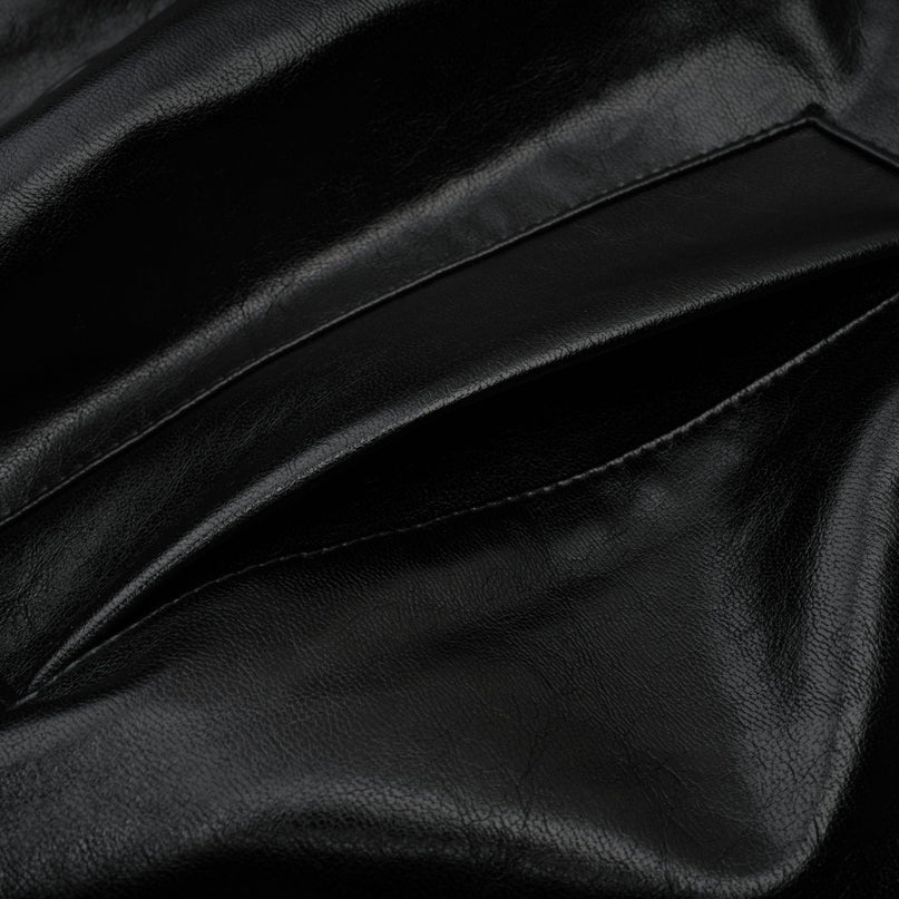 A short quilted leather jacket in black featuring a sleek design with front zipper closure and standup collar